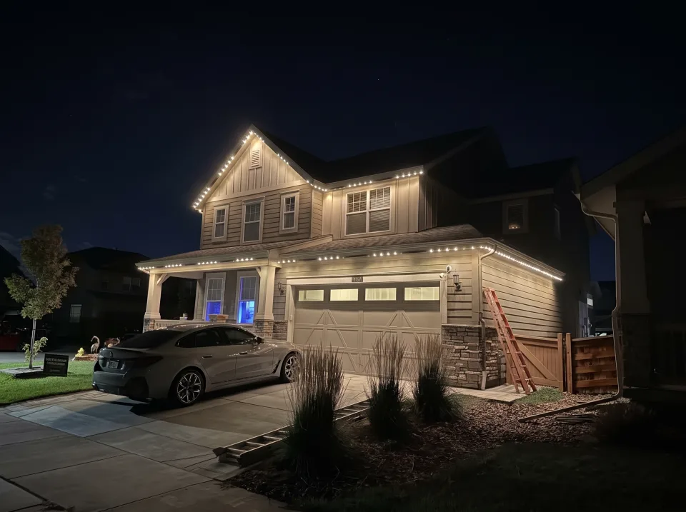 The same home with warm white accent lighting along the roofline